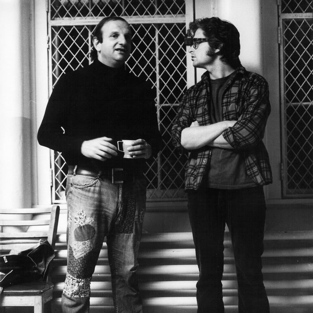A behind the scenes photo of Bo Goldman and Michael Douglas on the set of "One Flew Over the Cuckoo's Nest" in 1975.