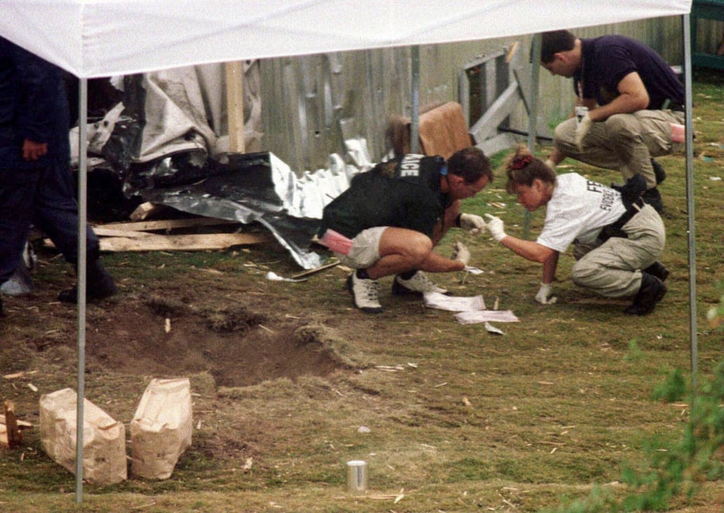Federal agents search for evidence following the 1996 Olympic Games bombing.