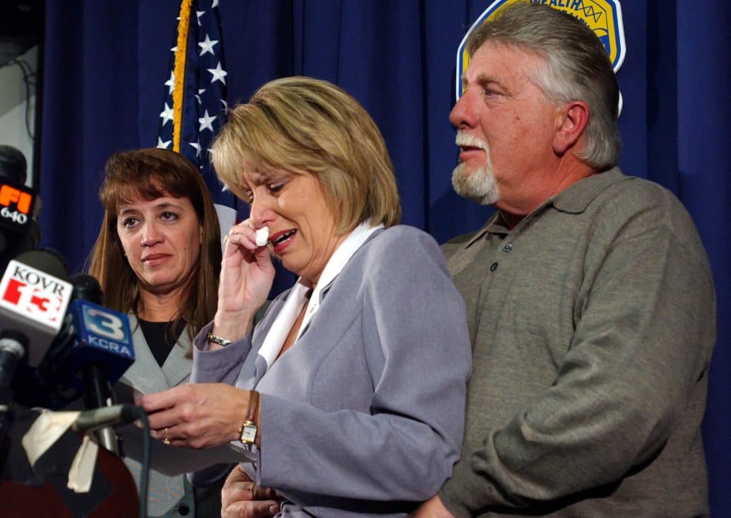 Laci Peterson’s mom, Sharon Rocha, is comforted by her husband Ron Grantsk during a press conference.  