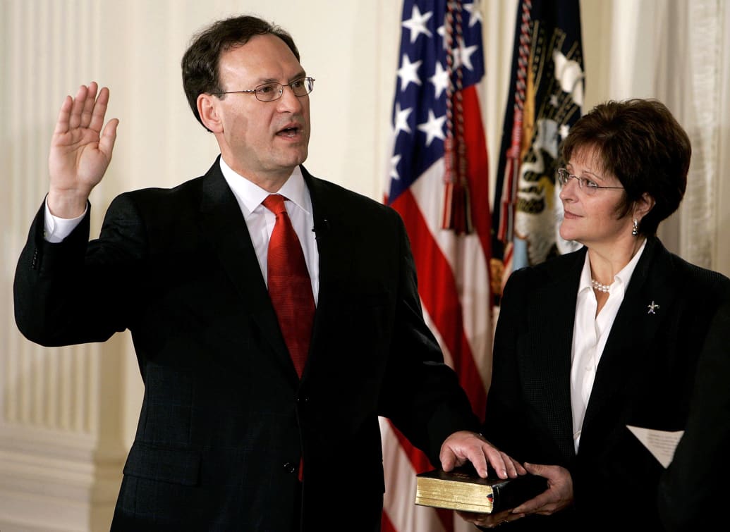 Samuel Alito is sworn in as Associate Justice of the U.S. Supreme Court as his wife Martha-Ann Alito holds a bible.
