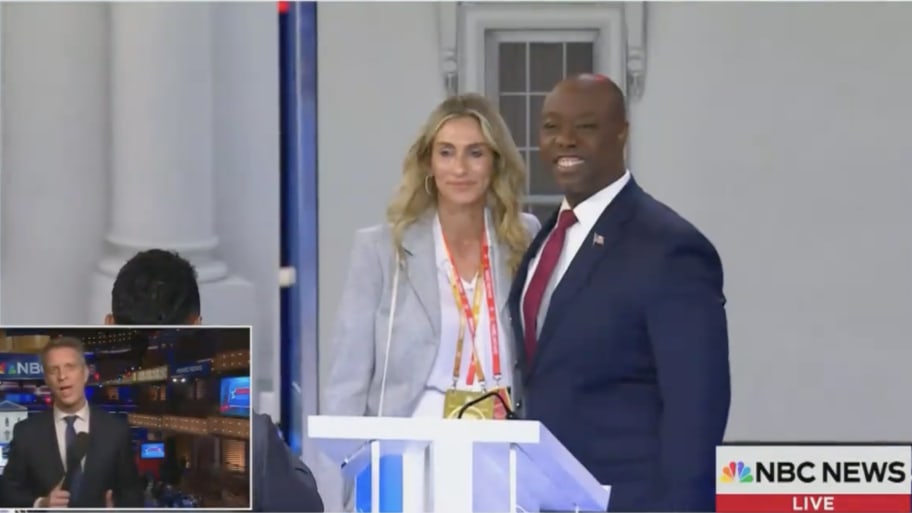 Tim Scott smiles with a mystery woman after Wednesday’s third GOP debate.