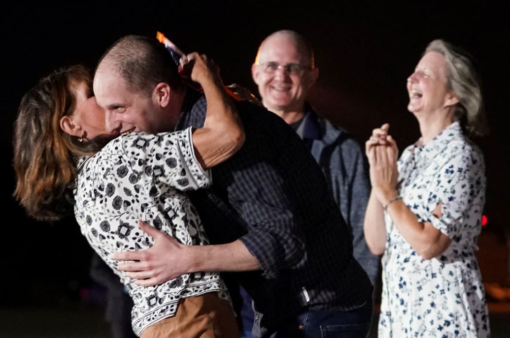 Evan Gershkovich embraces his mother on a tarmac