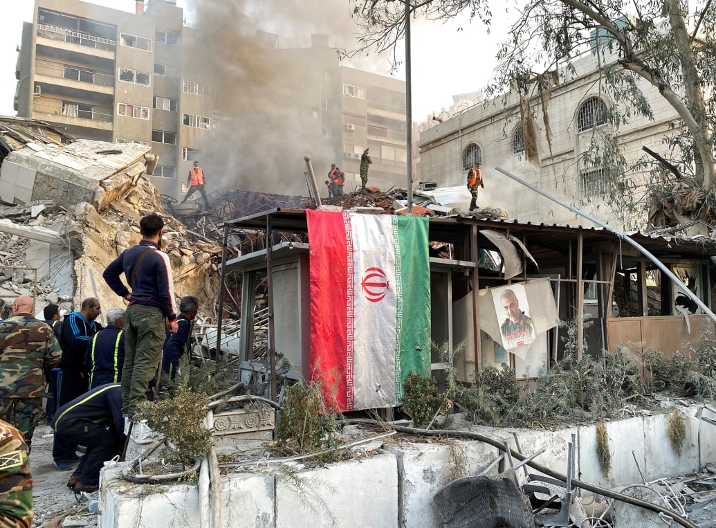 An Iranian flag hangs near the site of an attack close to the Iranian embassy in Damascus, Syria.