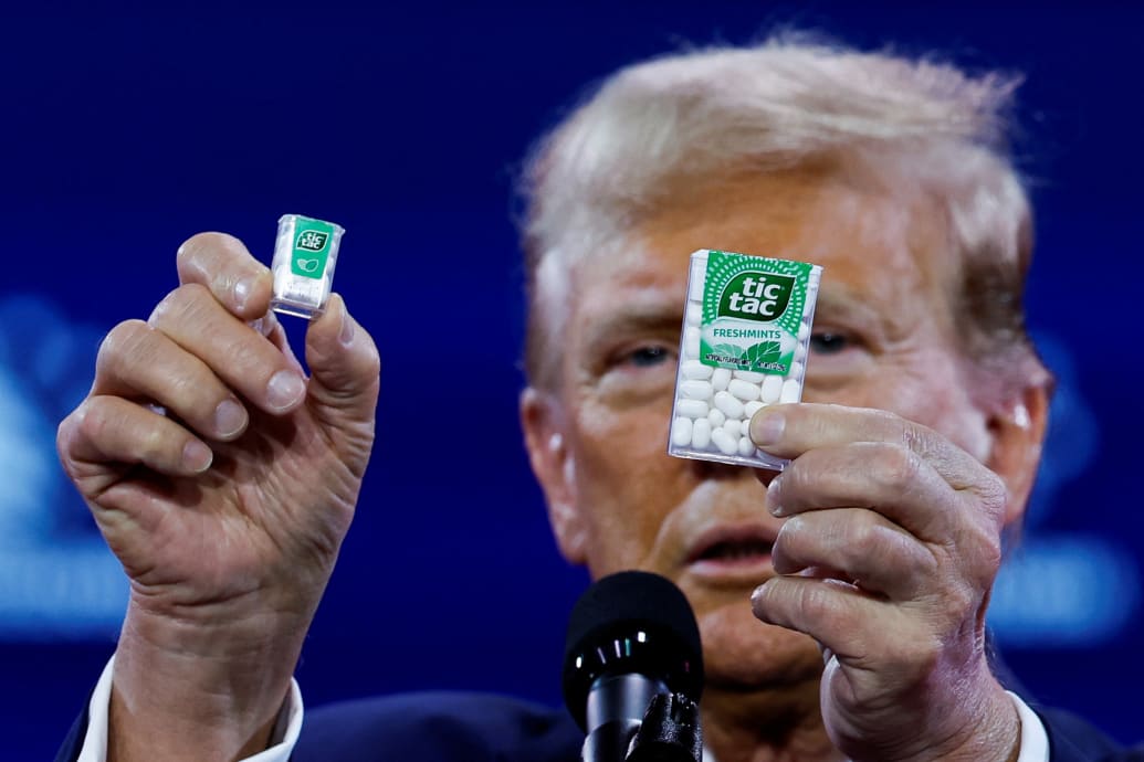 Former U.S. President and Republican presidential candidate Donald Trump holds Tic Tac containers while talking about inflation.  