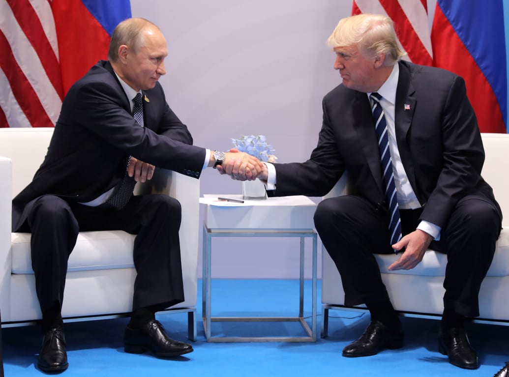 An image of President Donald Trump shaking hands with Russian President Vladimir Putin in 2017.