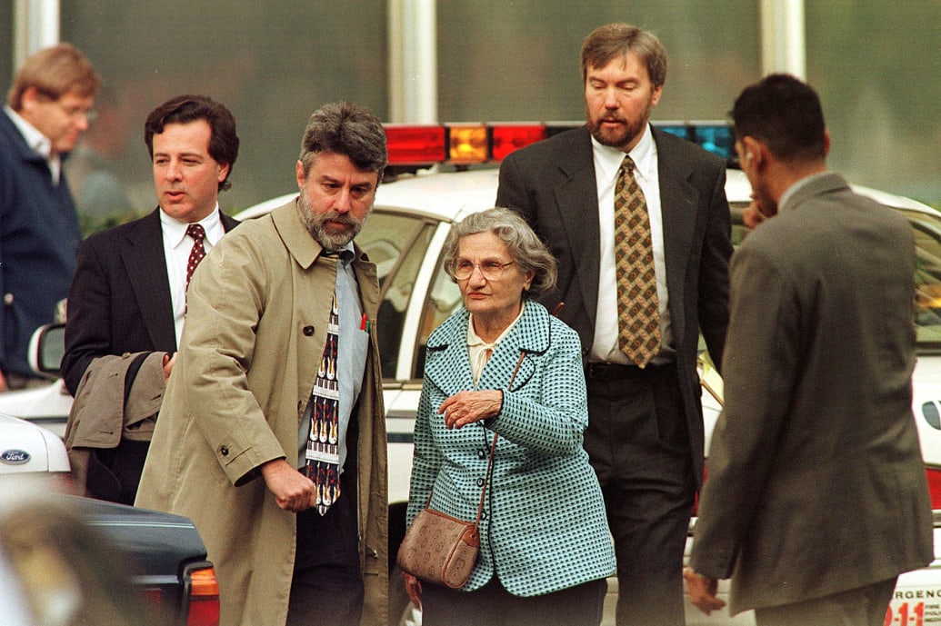 Wanda Kaczynski and her son David Kaczynski are escorted to their car.