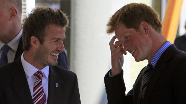 Prince Harry shares a joke with David Beckham during a reception in Johannesburg