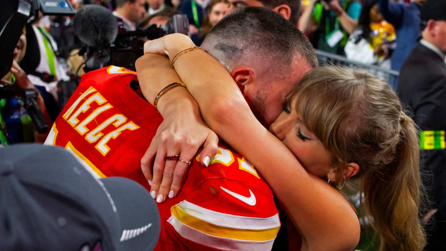 Travis Kelce embraces Taylor Swift on the field after the Super Bowl on Sunday.