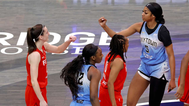 Chicago Sky forward Angel Reese (5) and Indiana Fever guard Caitlin Clark (22) fist bump before the opening jump ball