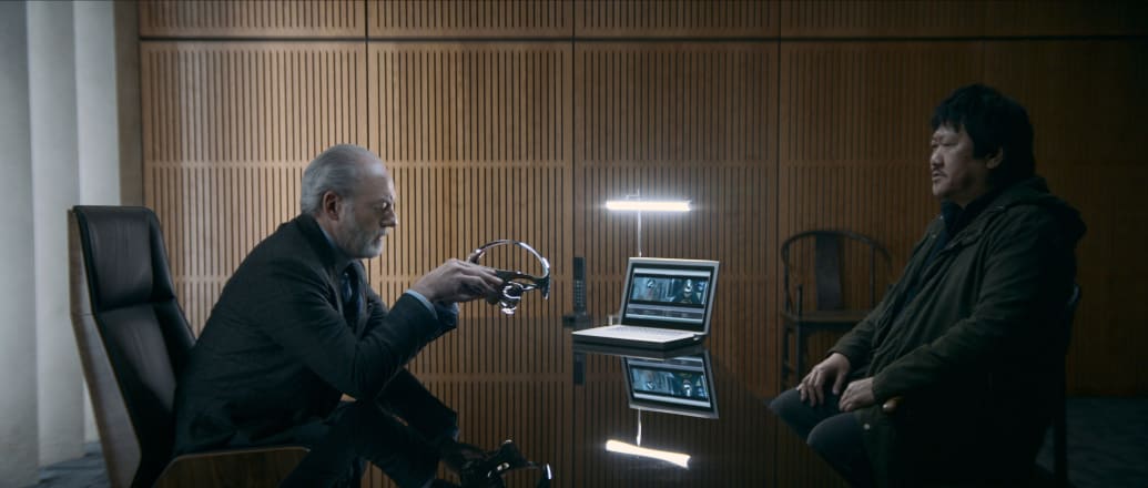 Liam Cunningham as Wade, Benedict Wong as Da Shi with the San-Ti technology.