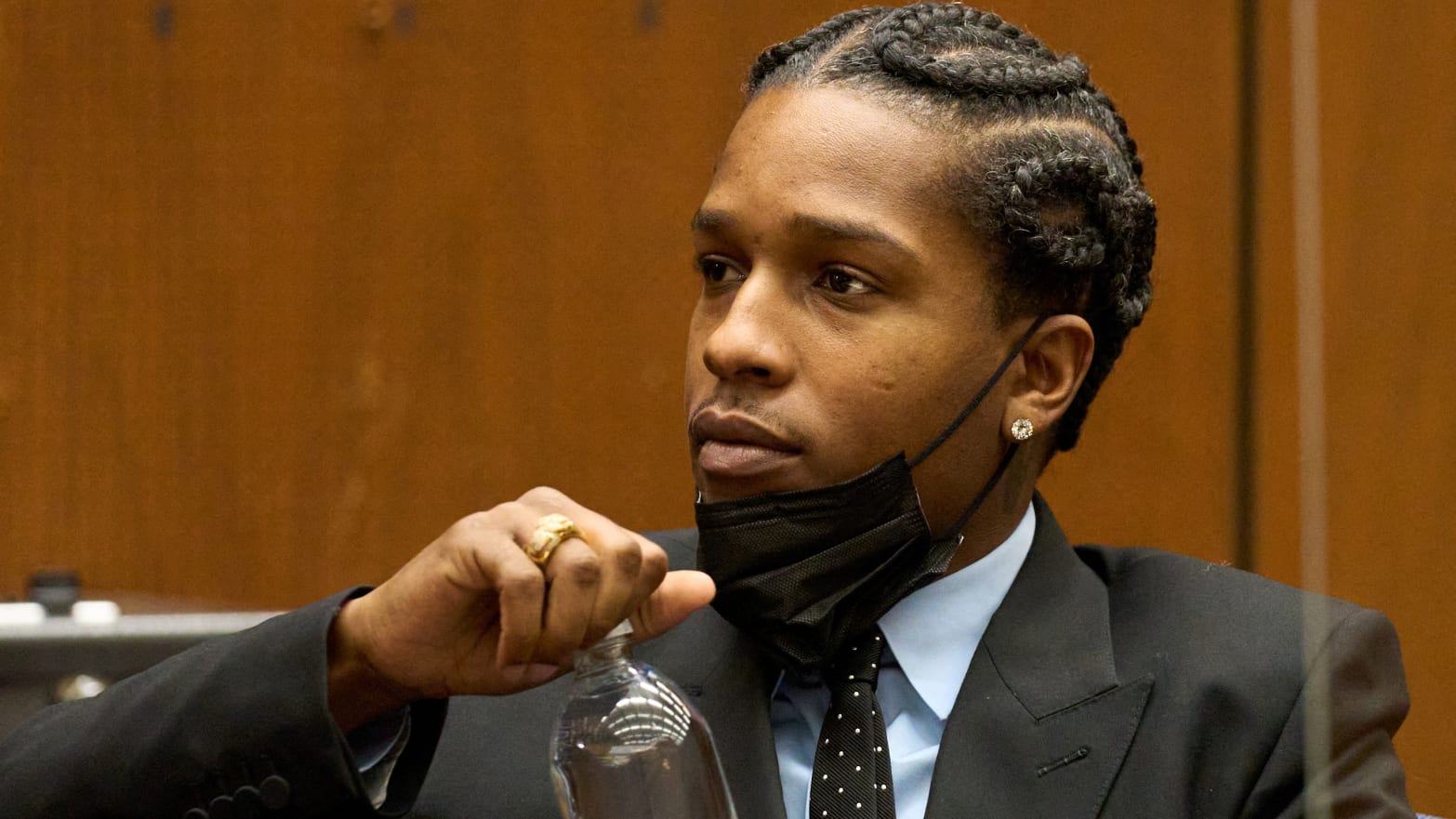 A$AP Rocky opens a bottle of water in a Los Angeles courtroom.