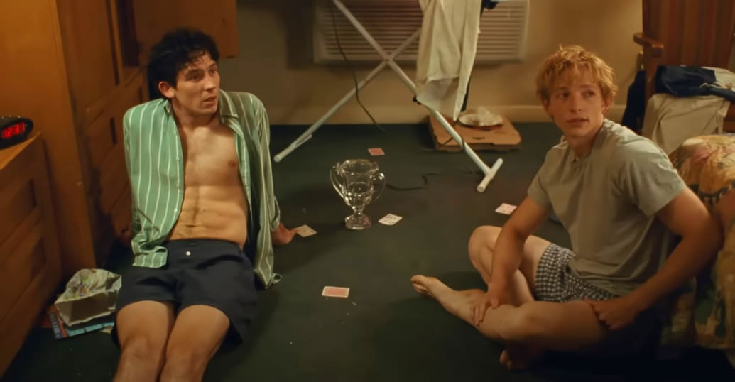 Josh O'Connor and Mike Faist sit on the floor in a still from "Challengers"