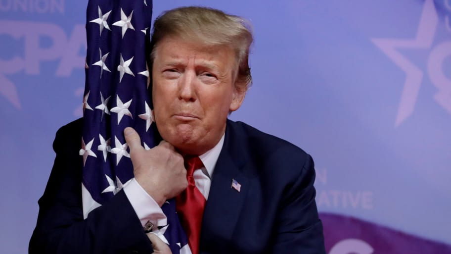 Donald Trump hugs American flag at the Conservative Political Action Conference (CPAC) annual meeting at National Harbor near Washington, D.C., March 2, 2019. 