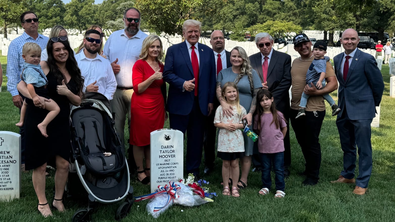 Donald Trump smiles with the loved ones of a fallen marine.