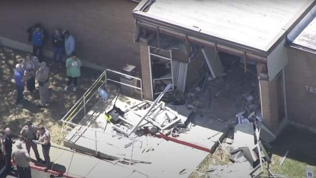 One person was killed, and fourteen others injured in Brenham, Texas on Friday when a stolen big rig truck smashed through the front of the Department of Public Safety office building.
