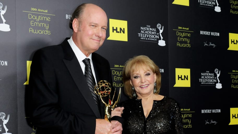A picture of producer Bill Geddie (L) is accompanied by television personality Barbara Walters (R) after receiving the Emmy for Lifetime Achievement.