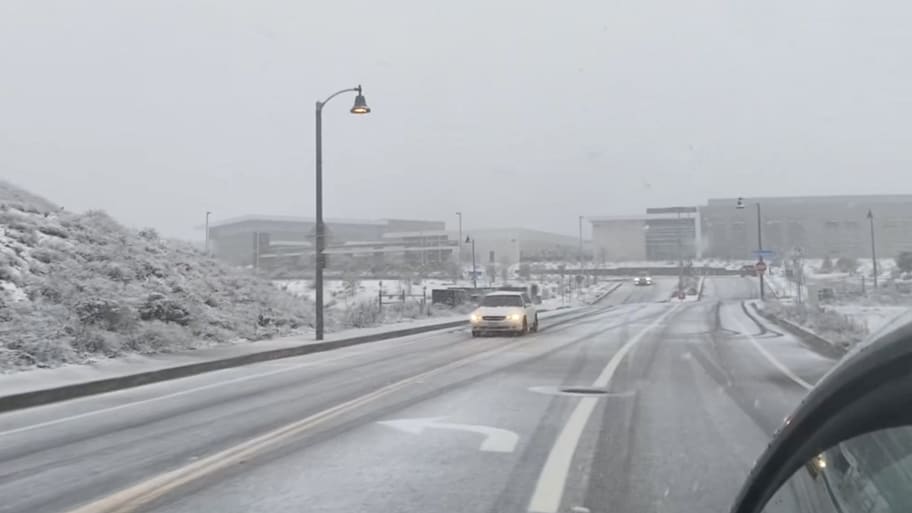 Vehicles transit in snow-covered roads in Castaic, in Los Angeles County, California, U.S., February 25, 2023 in this screengrab obtained from a social media video.