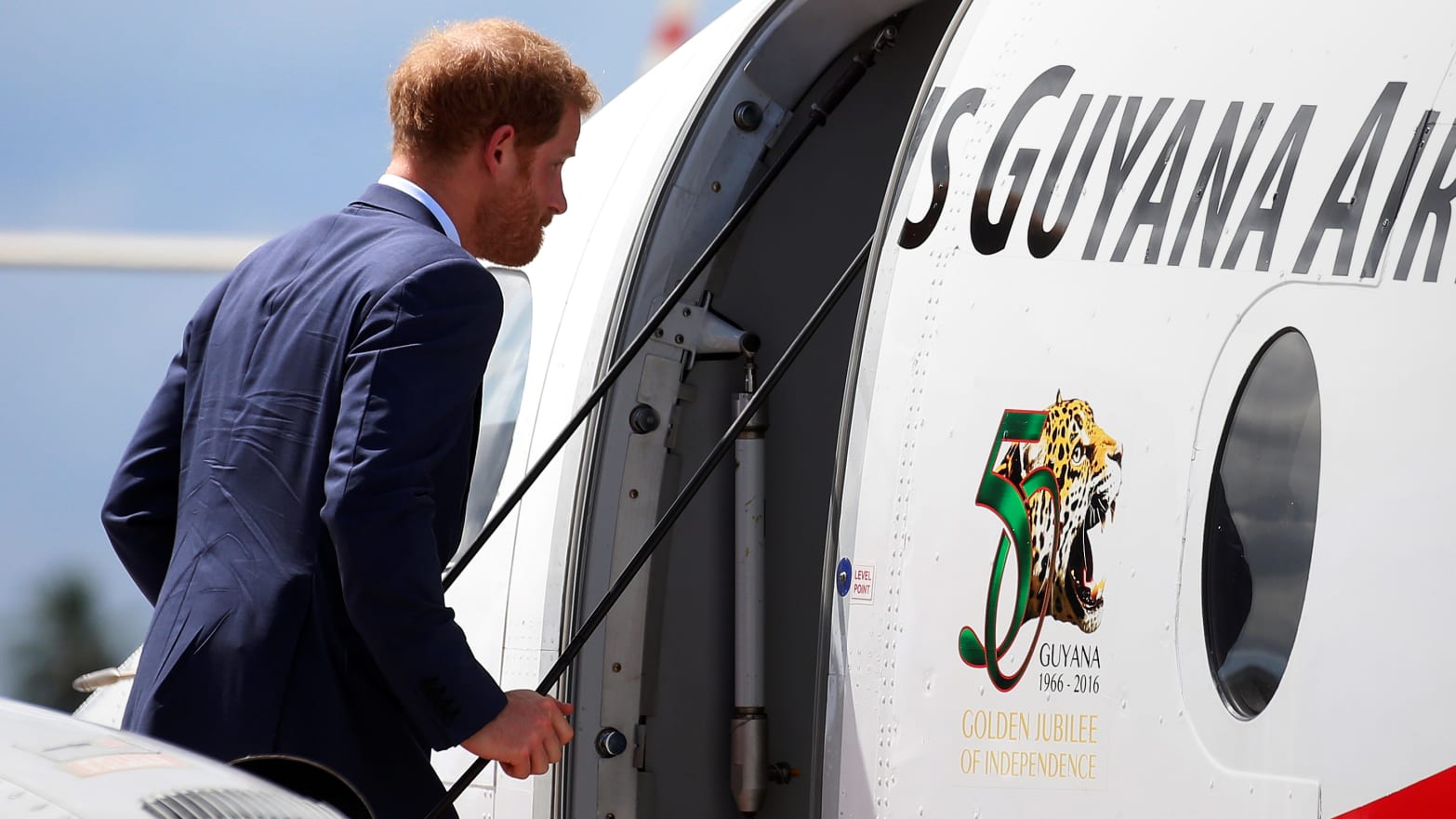Britain's Prince Harry boards a plane