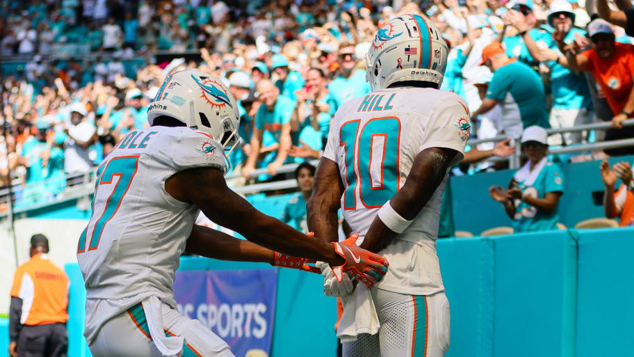 Tyreek Hill celebrates a touchdown by placing his hands behind his back.