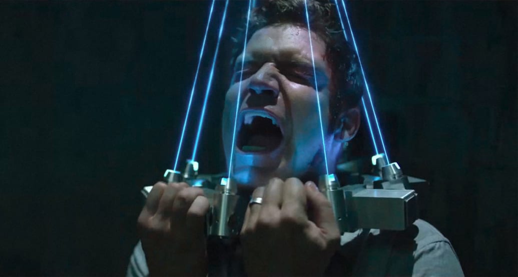 Matt Passmore in 'Jigsaw' with a collar made of lasers on his head
