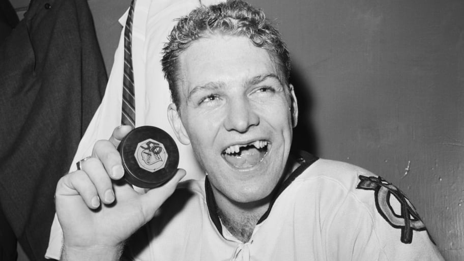 The puck Hull is holding is the one he launched past Ranger goalie Lorne Worsley, making Hull only the third person in the history of the NHL to score 50 goals in a season.