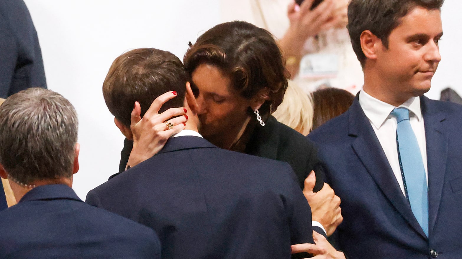 French minister of Sport Amélie Oudéa-Castéra (CR) hugs France’s President Emmanuel Macron (CL) at the Trocadero following the opening ceremony of the Paris 2024 Olympic Games in Paris.