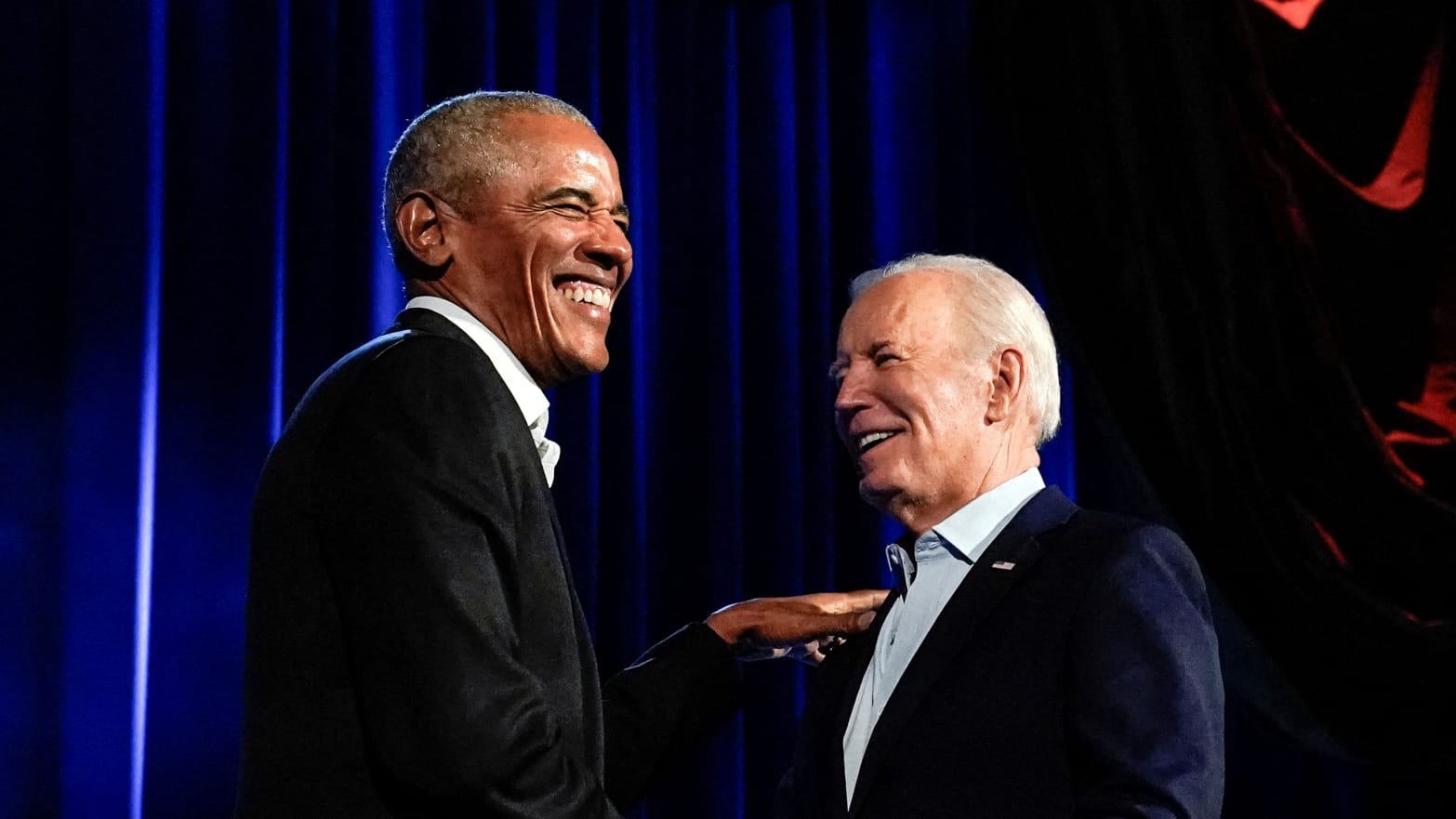 Barack Obama laughing with Joe Biden