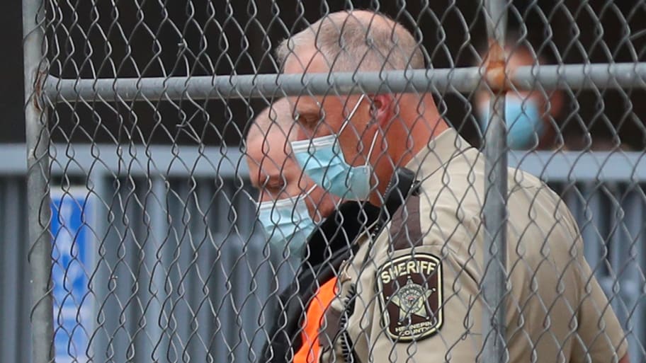 A law enforcement officer goes down while opening a gate for fired Minneapolis police officer Derek Chauvin