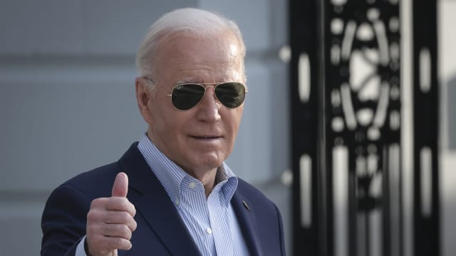 U.S. President Joe Biden wears aviators and gives thumbs-up to camera