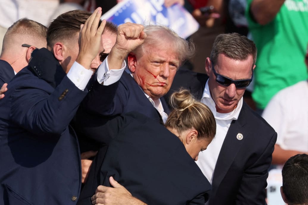 Trump seen directly fist pumping and blooded