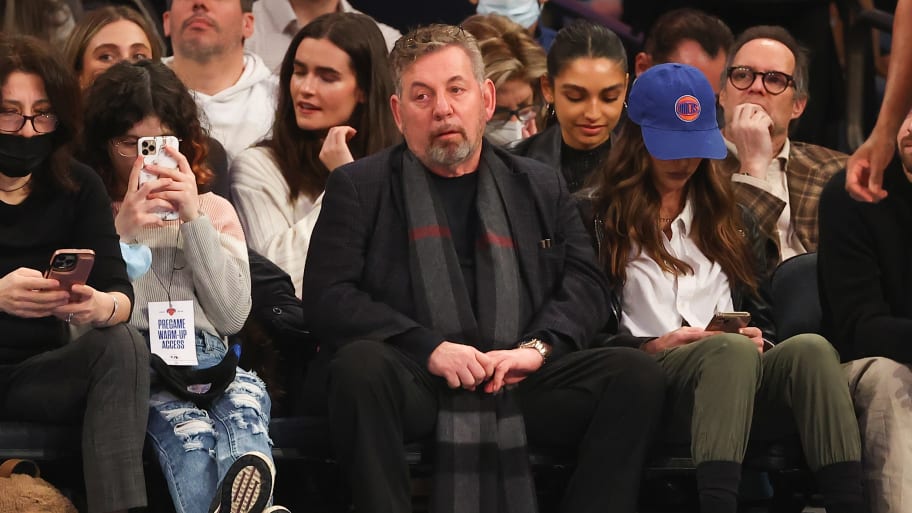 James Dolan sits courtside at a Knicks game