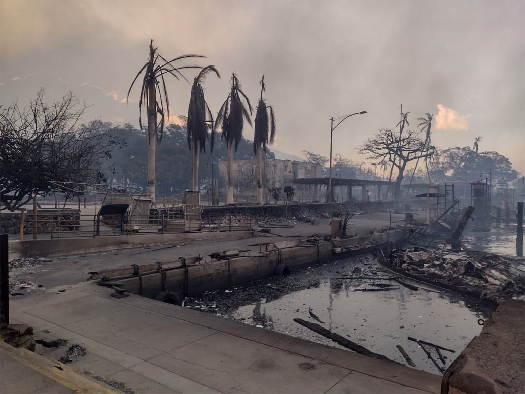 A charred boat lies in the scorched waterfront after wildfires devastated Maui's city of Lahaina, Hawaii.