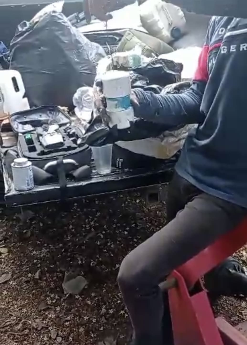 A screenshot from a video shared by a Jalisco New Generation Cartel member while preparing an explosive load.