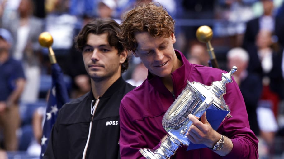 Italy's Jannik Sinner looks at the trophy after winning his men's final match against USA's Taylor Fritz 