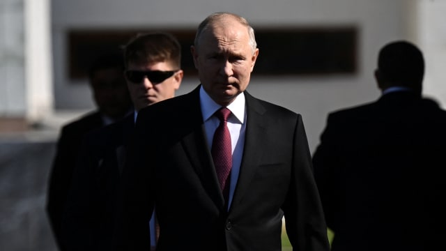 Russian President Vladimir Putin walking.
