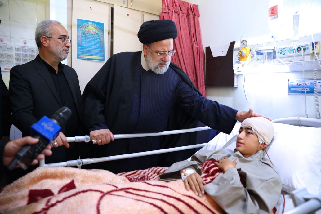 Iran's President Ebrahim Raisi visits one of the injured in the Islamic State attack in Kerman, in a Hospital in Kerman, Iran, January 5, 2024.