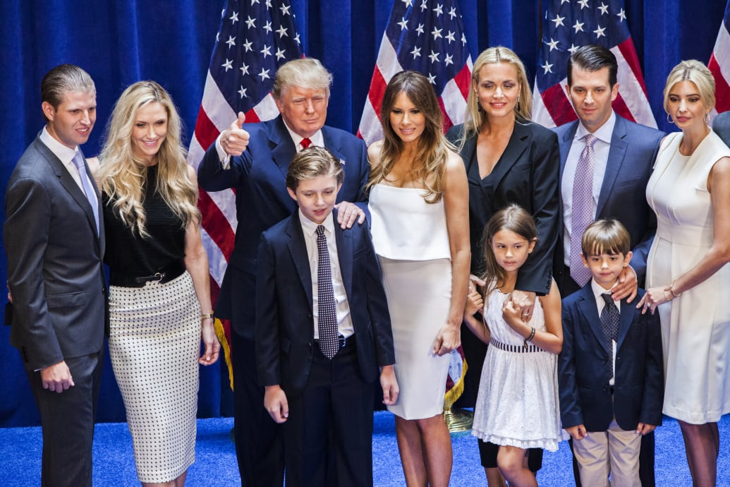 Trump making a thumbs up sign surrounded by Eric, Lara, Barron, Melania, Vanessa, Kai, Don Jr., Ivanka