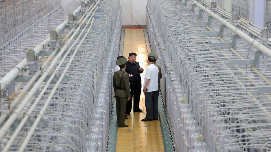 North Korean leader Kim Jong Un confers with military advisors in a uranium enrichment facility.