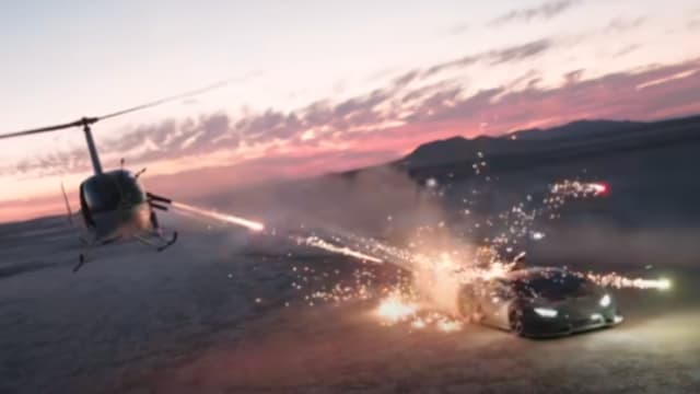 A screenshot from a video showing a Lamborghini Huracan being shot at with fireworks from a helicopter.