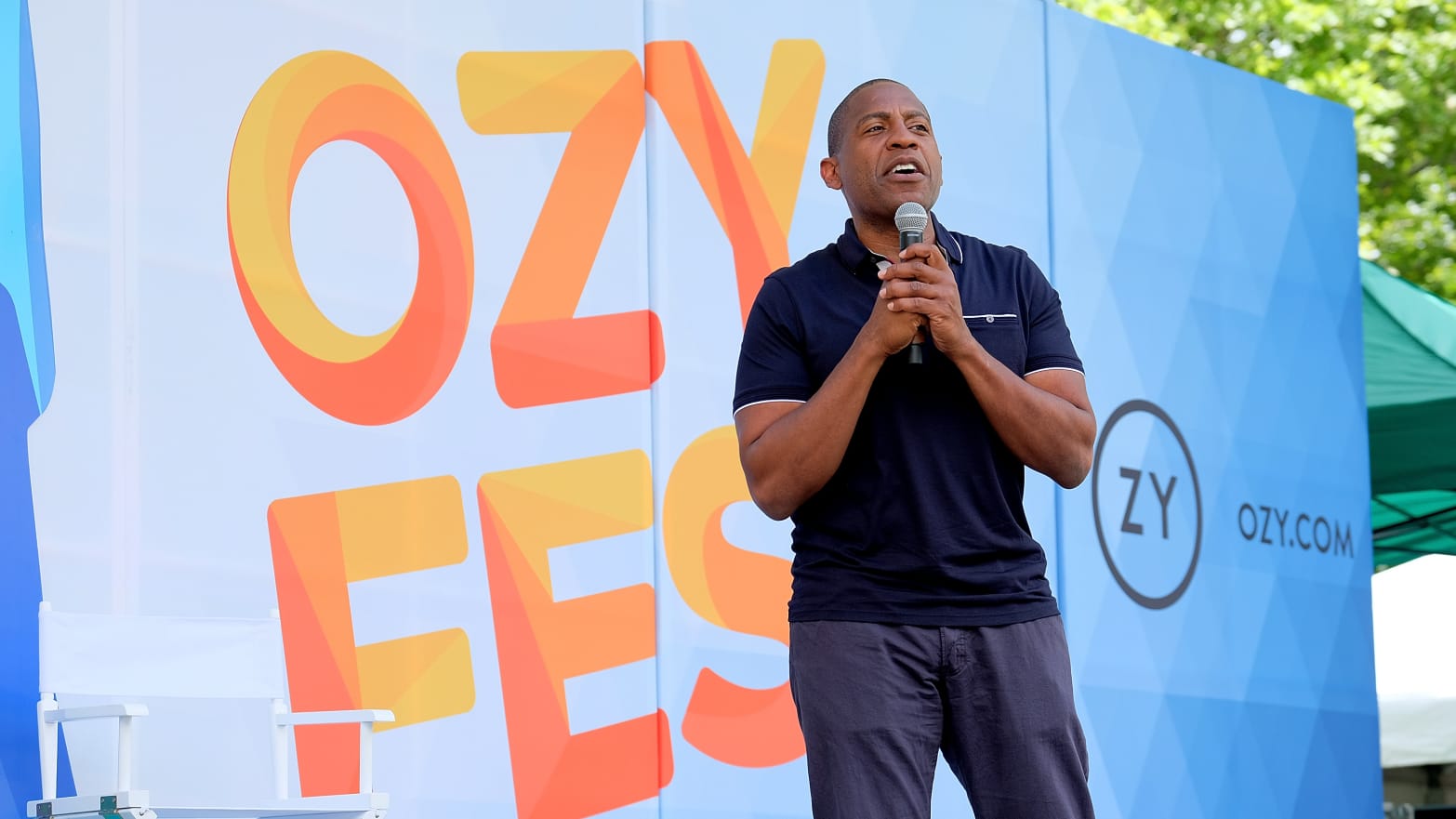 A photo of Ozy founder Carlos Watson onstage at Ozy Fest.