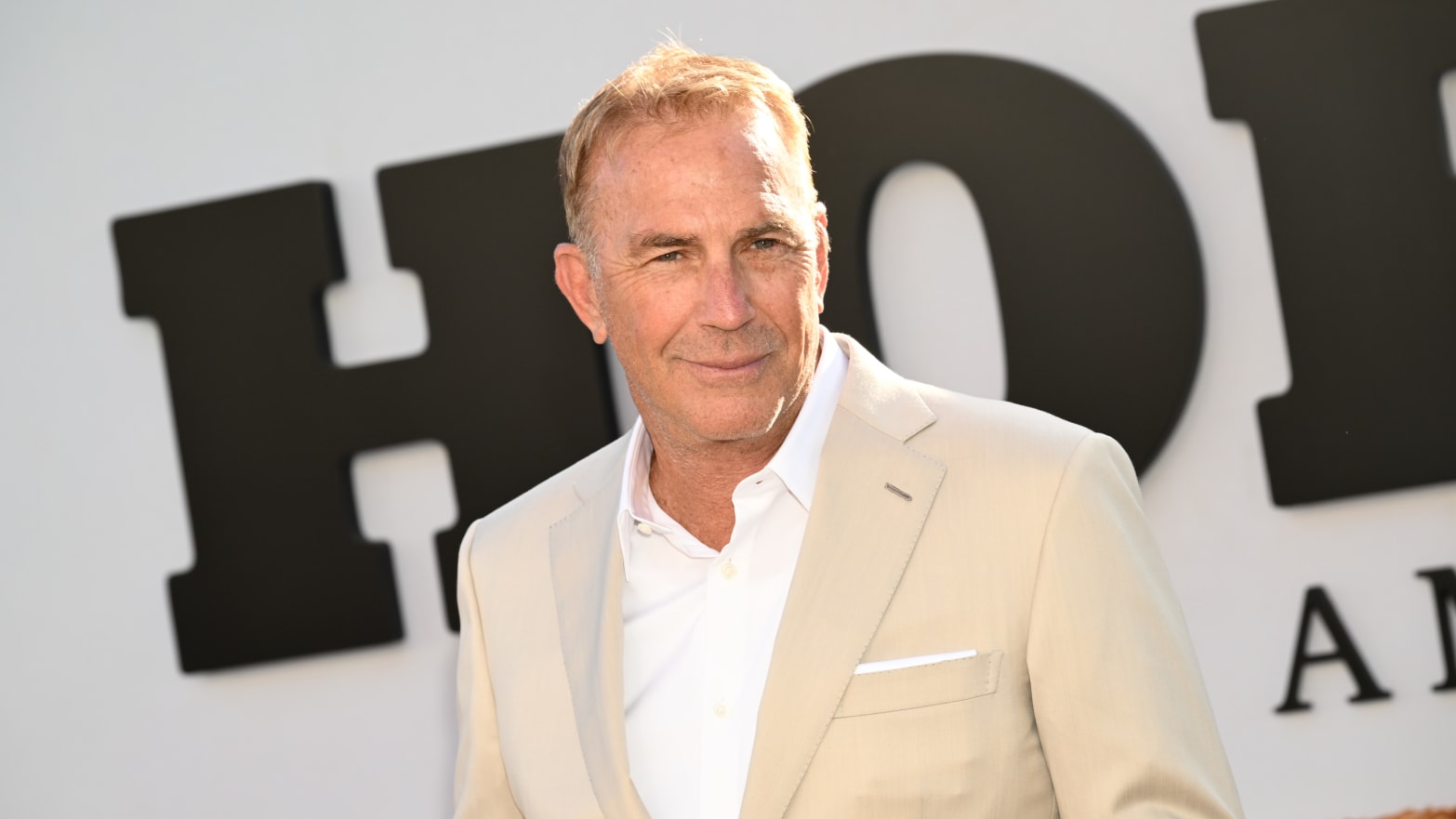 A photo of Kevin Costner on a red carpet