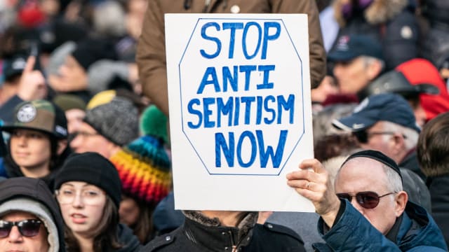 Photograph showing a support sign reading “stop antisemitism now”
