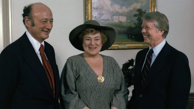 A photo of late Rep. Bella Abzug standing with former New York City Mayor Ed Koch and former President Jimmy Carter. 
