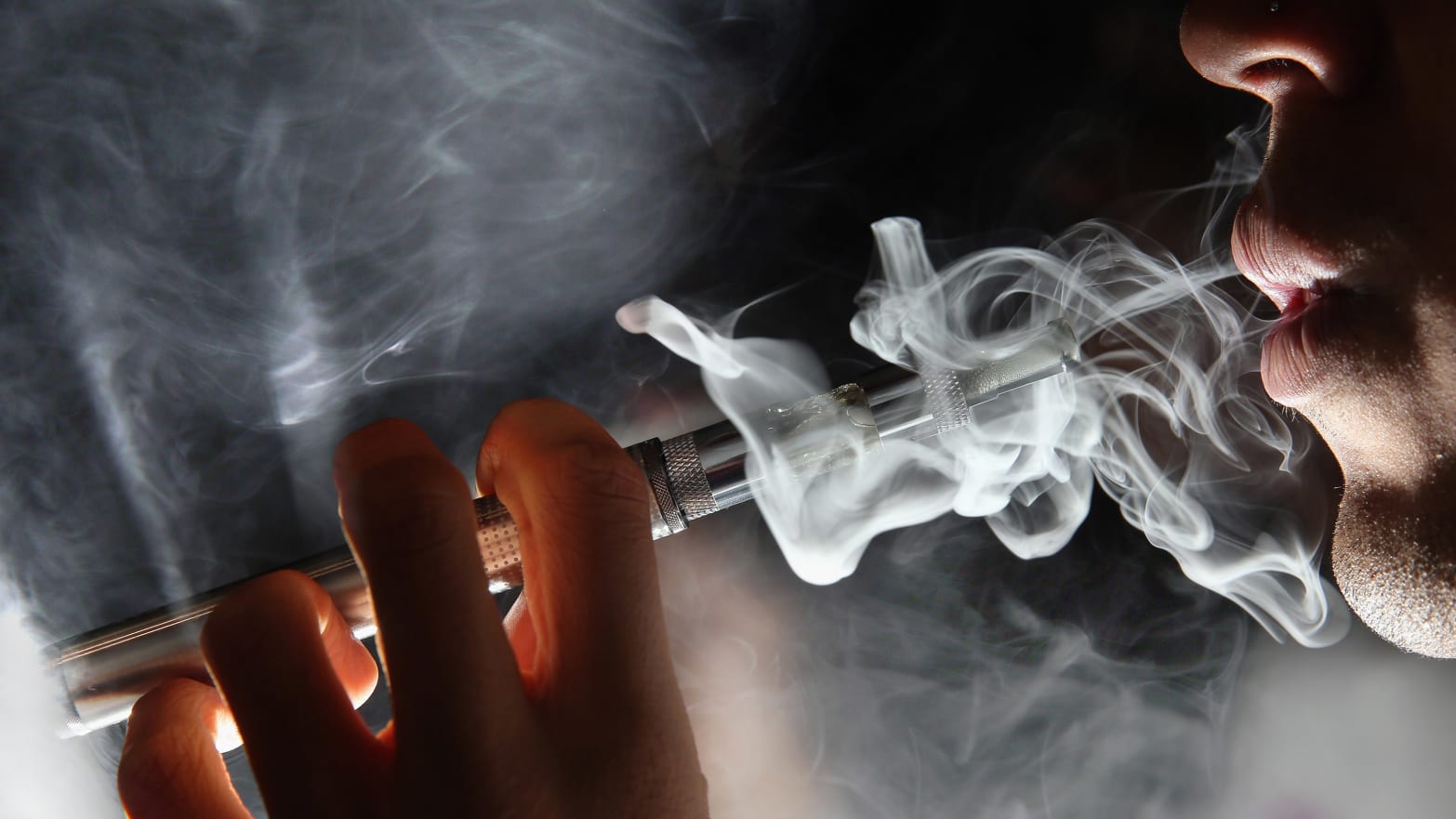 close up of a man smoking a vape e cigarette ecig cig fda scott gottlieb seizures smoke nicotine link teen youth young adult