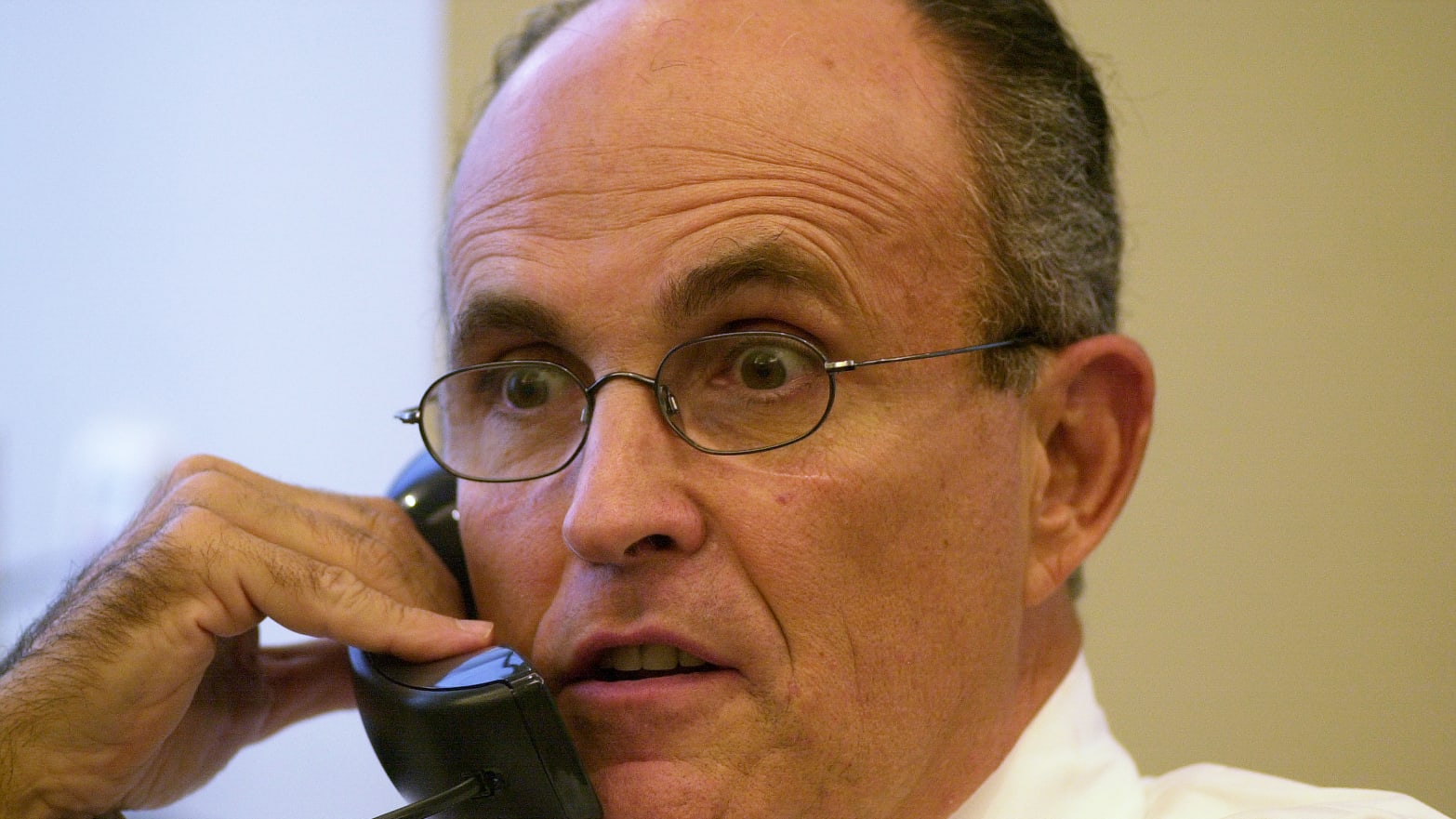 Former Mayor Rudy Giuliani chats on the phone at Times Square offices of his consulting firm, Giuliani Partners.