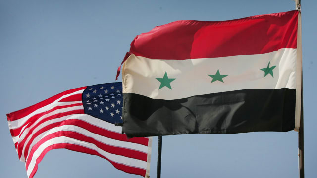 Iraqi and U.S. flags fly over al-Asad air base August 29, 2005 in Al Asad, Iraq.