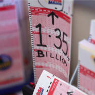 A photo of a batch of blank lottery tickets waiting to be filled out. On one of them, someone has written in black marker, “1.35 billion,” the jackpot.