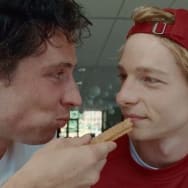 A photo still of Josh O'Connor and Mike Faist eating a churro in 'Challengers'