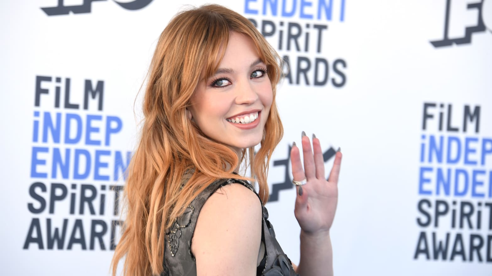 Sydney Sweeney waves to the camera at the Spirit Awards in 2022.