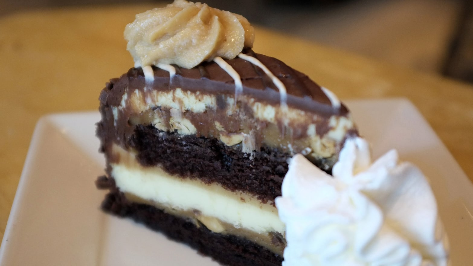 A slice of Reese’s peanut butter chocolate cake cheesecake is pictured at a Cheescake Factory restaurant in Boston, Massachusetts, July 30, 2014.